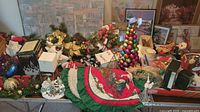 Overview of Christmas-themed ornaments and decor including bauble tree, fabric tree skirt, and assorted boxes