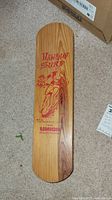 Full front view showing wood deck and red “Hawaiian Surf” graphic