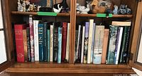 Shelf showing multiple art and gardening books including Canadian Who's Who, The Dyer's Art, and Picasso titles.