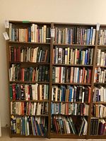 Two bookshelves side by side filled with books to show shelving size and usage.