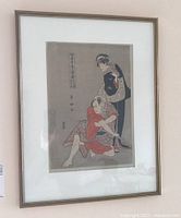 Framed Japanese Ukiyo-e print hanging on wall with visible front view of the artwork.