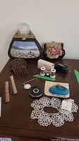 Full view of all vintage ladies' accessories including opera glasses, clutches, combs, lace collar, mirror, and cosmetic containers