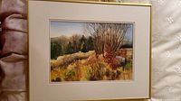 Full view of framed watercolor depicting a natural landscape with trees and bushes in autumn colors.