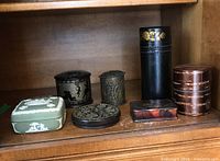 Full set of seven assorted trinket boxes including Wedgwood jasperware and various carved wax and metal boxes, showing shapes, colors and decoration.