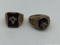 Front view of both Masonic rings showing faces and symbols