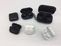 Overview of all six earbud sets with cases opened or closed