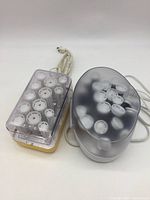 Both Clairol and Remington hot roller sets with lids and cords