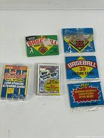 All six sealed baseball card packs laid out for overview