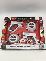 Front of sealed FAO Schwarz Duel Blast Laser Tag 2-Player Action Set showing blasters and targets through window.