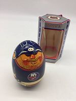 Wobble doll figure front view with box behind