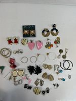 Full overhead view showing all assorted earrings laid out