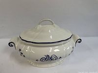 Tureen front view showing lid, handles and blue decoration