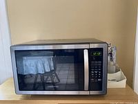 Front view of the Farberware microwave oven on countertop showing digital control panel and door.