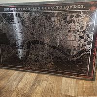 Full view of the metallic London map wall decor, showing framed map with detailed city layout and distressed finish.
