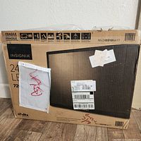 Box of the Insignia 24-inch LED TV with model and barcode labels visible, showing the product new and sealed.