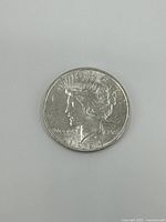 Obverse side of the 1924 silver Liberty dollar coin showing Lady Liberty profile with crown and inscriptions.