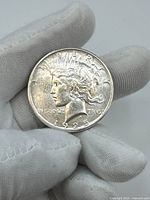 Obverse side of the 1925 Liberty Dollar coin showing the Liberty head, date, and inscriptions.
