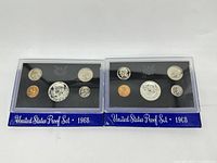 Two 1968 proof sets in original plastic display holders with blue bases, showing all five coins each.