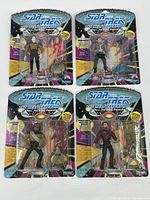 Overview of all four Star Trek The Next Generation action figures still sealed in original packaging, showing front of blister cards with action figures and accessories.