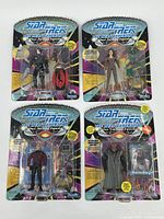 Photo of 4 sealed Star Trek: The Next Generation action figures in original blister packaging
