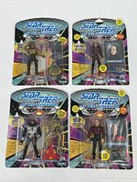 Four sealed Star Trek The Next Generation action figures in original Playmates packaging, showing front of carded figures.