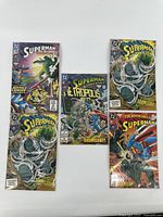 Five Superman comic books each in own bag and board showing covers with Doomsday theme