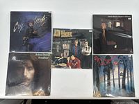 Lot of 5 vinyl records in sleeves laid out flat showing cover art for identification.