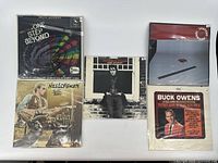 Overview of the five vinyl records in sleeves showing album art and sleeves.