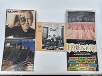 Five vinyl records laid flat showing front covers including Ian Gomm, Chris Hillman Desert Rose, Desert Rose Band, abstract pink cover, and Hot Enanny collection sleeve.