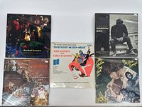5 vinyl records arranged with cover artwork visible including Marshall Crenshaw, Thoroughly Modern Millie soundtrack, Gordon Bok, and two others.