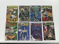 Full lot of 8 Mars Attacks comic books laid out showing colorful covers and varying issues from the series.