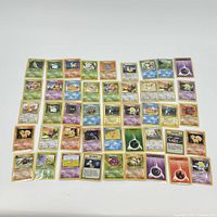 Photo showing all 45 Pokémon cards laid out in rows, sleeved individually, with a variety of Pokémon types and cards visible.