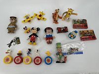 Full overview of 20 toys including Disney, Peanuts, small planes, and collectible cards