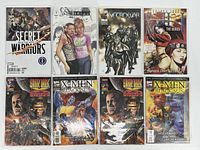 Photo of all 8 comic books laid out in two rows showing cover art and variety in titles and genres.