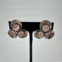 Front view of both sterling silver earrings with rose quartz stones, one stone missing on one earring.