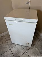 Front and top angled view of the white chest freezer showing overall size and condition.
