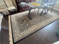 Full view of rug under dining table, showing overall size, placement, and pattern