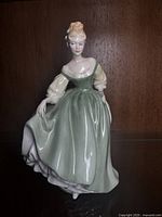 Front view of the Royal Doulton Fair Lady figurine showing the detailed dress and painted face.