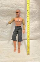 Photo showing the full body of the 12-inch Big Jim Dr. Steel figure standing next to a measuring tape for scale.