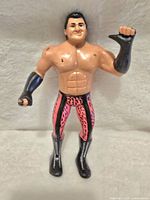 Front view of the Brutus The Barber Beefcake action figure showing painted details and muscular build.