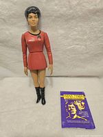Front view of the Uhura figure and purple vintage card wrapper with Star Trek graphics and text.