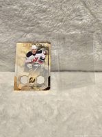 Front view of Ilya Kovalchuk dual jersey card with two embedded white fabric pieces, registered as 055/150, with gold border design.