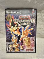 Front cover of the PlayStation 2 game case showing official Limited Edition Yu-Gi-Oh! Capsule Monster Coliseum artwork featuring a character and chess-like figures.