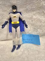Photo shows vintage N.J Croce bendable Batman figure standing against a white background with a blue fabric cape and visible bendable limbs.