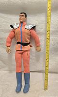 Front view of 12-inch M. Bison action figure with measuring tape showing height