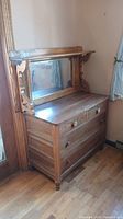 Full view of the 4 drawer wooden sideboard with detached mantle and mirror showing general condition and design.
