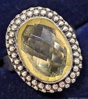 Close-up of the silver oval lemon quartz ring displaying the faceted gemstone surrounded by a beaded silver frame.