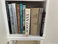 Shelf of 11 books with titles mostly on art and history subjects, showing book spines clearly for identification.