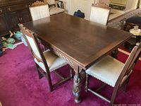 Full view of dining table and six chairs on red carpet