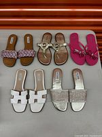 Top-down view of all six pairs of sandals showing variety of styles, colors, and brands.